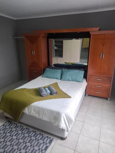 a bedroom with a bed with two pillows on it at KOUT Guest House in Alberton
