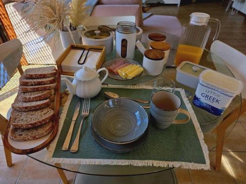 a table with a tray of breakfast food on it at Beautiful Holiday Home in Gold Coast
