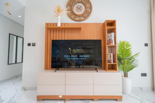 a fireplace in a living room with a tv at Stylish 3BR - Maryah Vista Luxe Escape in Abu Dhabi