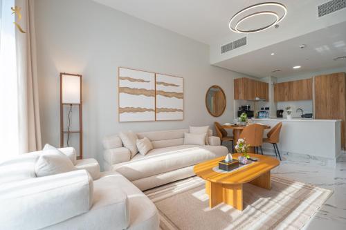 a living room with a white couch and a table at Stylish 3BR - Maryah Vista Luxe Escape in Abu Dhabi