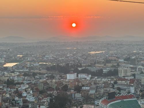 a view of a city at sunset at Golden Sunset - Appart'Hôtel in Antananarivo