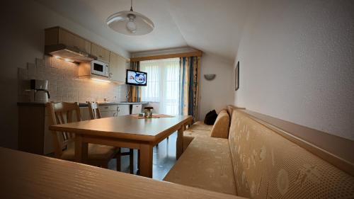 a small kitchen and dining room with a table at Chasa Monthani in Ischgl