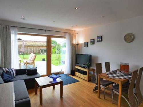 a living room with a couch and a table at Modern Apartment near Forest in Heinrichskirchen in Heinrichskirchen