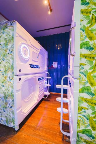 a room with a washing machine and a ladder in it at ZZZ Sleep Mode Capsules- Larkin in Johor Bahru