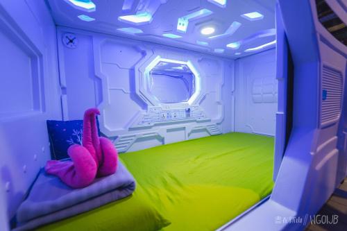 a room with a bed with pink flamingos on it at ZZZ Sleep Mode Capsules- Larkin in Johor Bahru