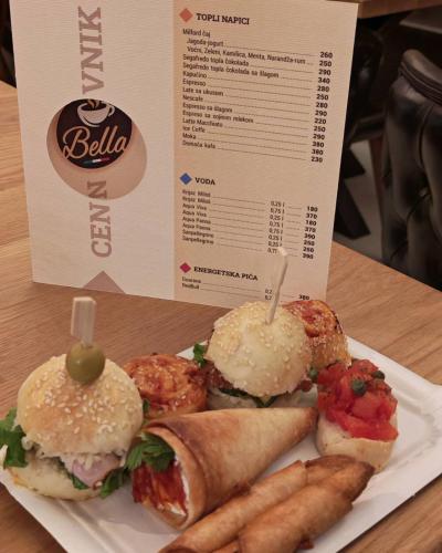 a plate of sandwiches and french fries on a table at POOL RESORT Vila Lena - Lux residence apartman 1 in Vrdnik