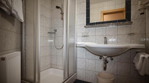 a bathroom with a sink and a shower at Chasa Monthani in Ischgl