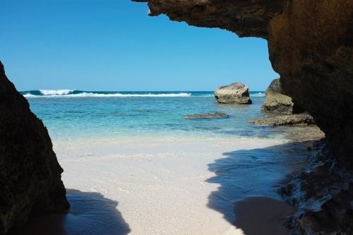 a view of the ocean from a cave on a beach at Studio Amanda in Nouvelle Découverte