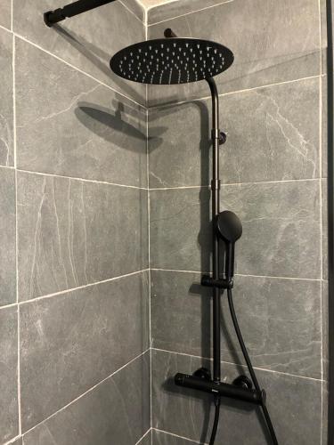 a shower with a shower head in a bathroom at Magnifique studio à 250 mètres des pistes avec tout inclus in Bolquere Pyrenees 2000