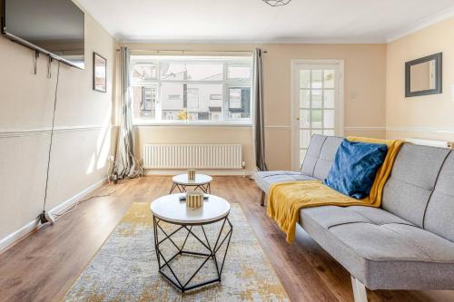 a living room with a couch and a table at Gorgeous 3 bed House - Free Parking near Elizabeth line in Abbey Wood