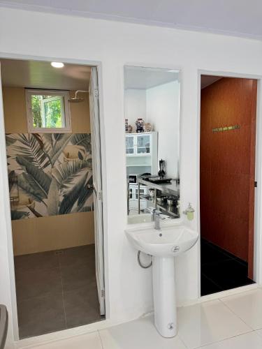 a bathroom with a sink and a kitchen at Panika family room in Malaybalay