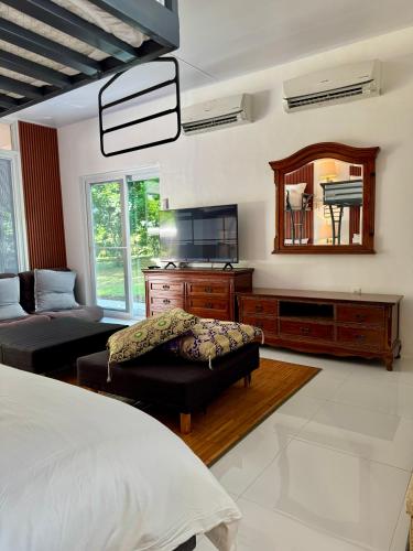 a bedroom with a bed and a mirror at Panika family room in Malaybalay
