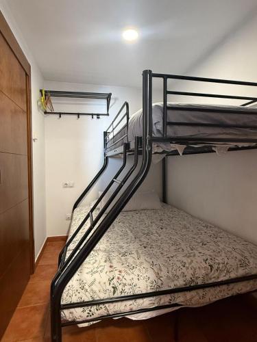 a bedroom with two bunk beds in a room at ESTUDIO LUNA in Sierra Nevada