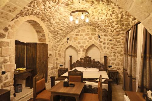 a bedroom with a bed in a stone building at De MARİA KONAĞI in Mardin