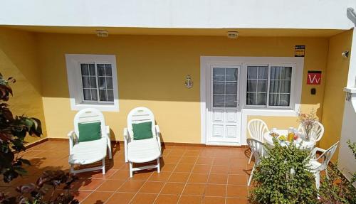 a group of chairs sitting on a patio at Vivienda Miramar in Villa de Mazo