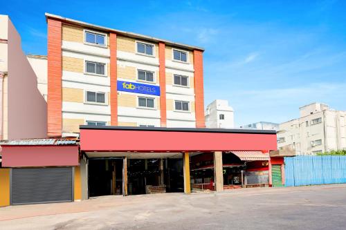 a building with a sign on the front of it at FabHotel Alfa in Vijayawāda