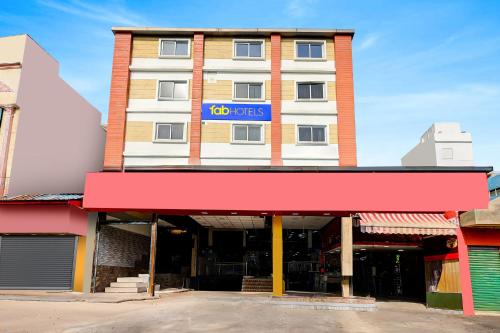 a building with a sign on top of it at FabHotel Alfa in Vijayawāda