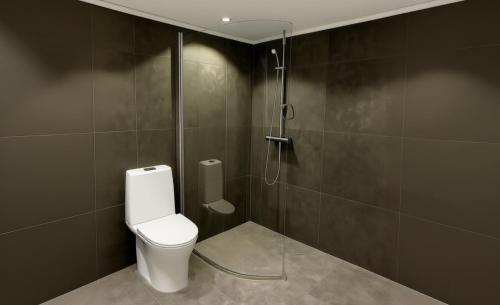 a bathroom with a toilet and a shower at Aurora Luxe Apartment Stay in Växjö