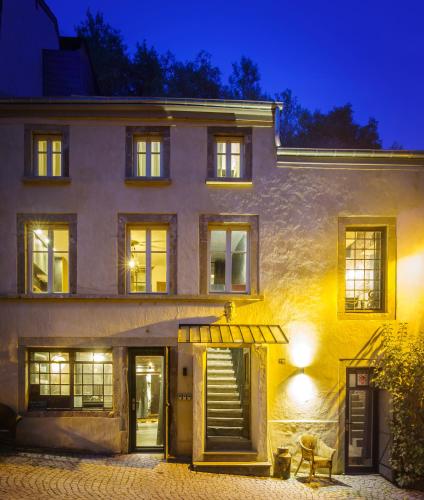 a building with a staircase leading up to it at night at Beim Mulles - Black Smith - Vianden in Vianden
