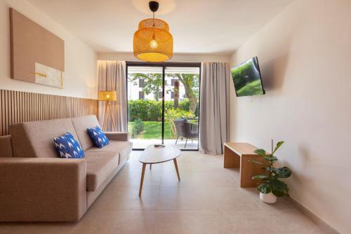 a living room with a couch and a table at Hotel Bahia Pollensa in Port de Pollensa
