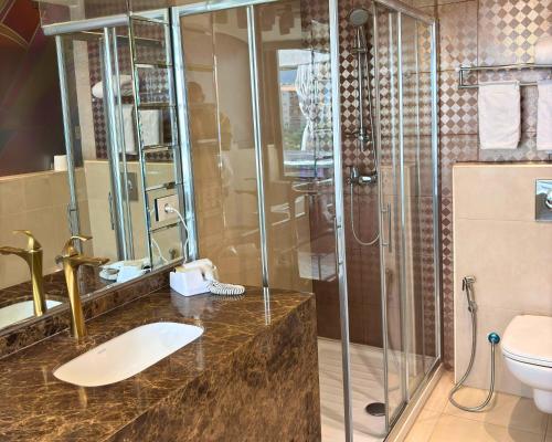 a bathroom with a shower and a sink and a toilet at Hotel Xperience in Jounieh