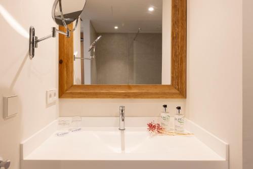 a bathroom with a sink and a mirror at Hotel Bahia Pollensa in Port de Pollensa