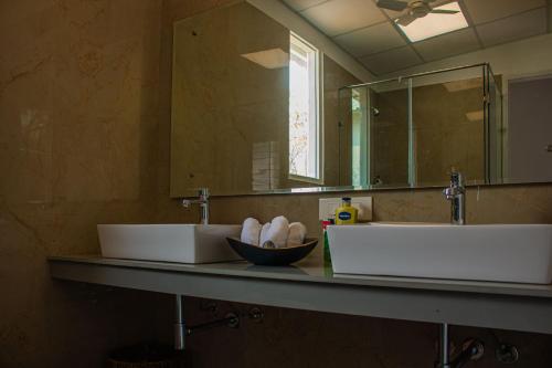 a bathroom with two sinks and a mirror at Baagh-Bohemian 6BHK Farmhouse, Jagatpura, Jaipur in Jaipur
