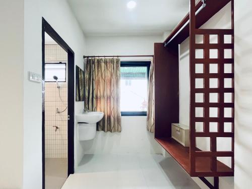 a bathroom with a toilet and a sink at Rendezvous Oldtown Chiangmai in Chiang Mai