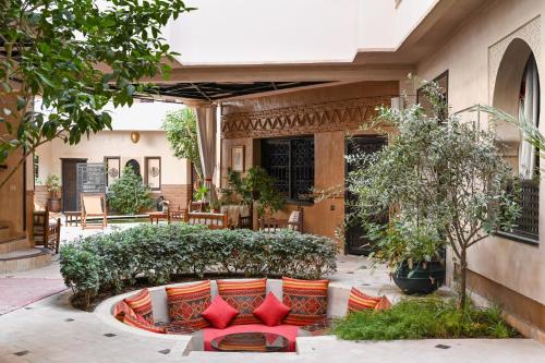 a house with red pillows on a patio at Les Sources Berbères Riad & Spa in Marrakech