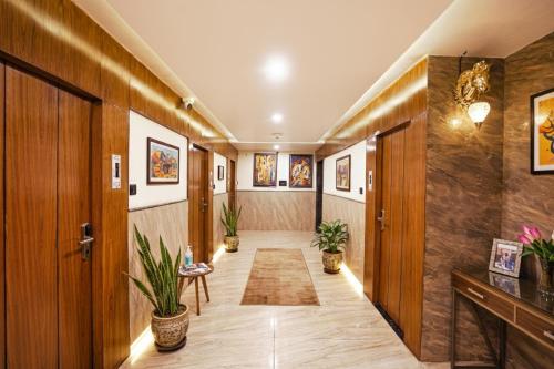 a hallway with wood paneling and potted plants at FabHotel Sarja Sky in Nagpur