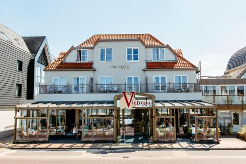 a large building with a store in front of it at Hotel Victoria in Bergen aan Zee
