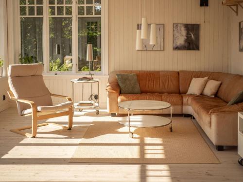 a living room with a couch and a table at Åkagårdens Lodge in Båstad