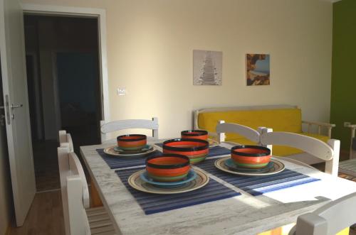 a table with four bowls and plates on it at Rezidenca Kalter Durres in Golem