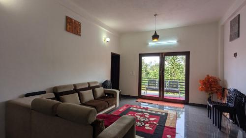 a living room with a couch and a table at Ridge Homestay in Mudigere