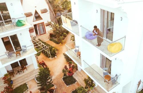 a person standing on a staircase in a building at La Perla Beach Resort, Zanzibar - Your Beachfront Private Haven in Pwani Mchangani