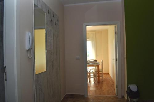 a hallway with a door leading to a room with a table at Rezidenca Kalter Durres in Golem