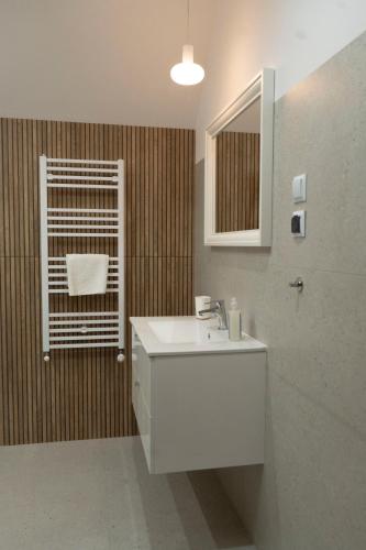 a bathroom with a white sink and a mirror at Motel DB2000 in Biłgoraj