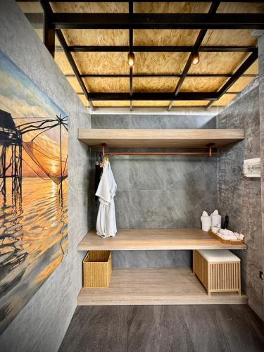 a room with a shelf and a painting on the wall at Awana Villa Resort Yaonoi - SHA Extra Plus in Ko Yao Noi