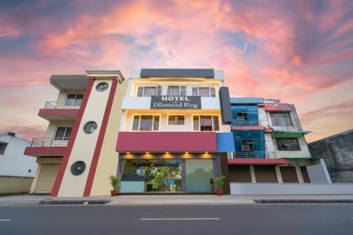 a hotel building with a sunset in the background at FabExpress Diamond Sec 45 in Chandīgarh