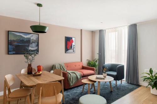a living room with a couch and a table at Cove Paradise Street in Liverpool