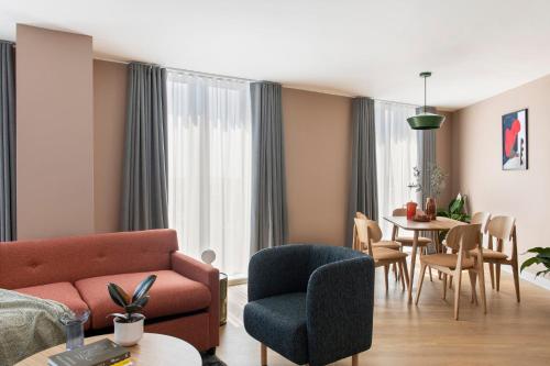 a living room with a couch and a table at Cove Paradise Street in Liverpool