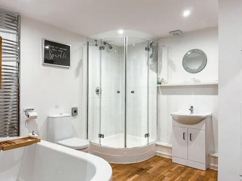 a bathroom with a shower and a tub and a sink at The Granary House - Long Stayz in Plymouth