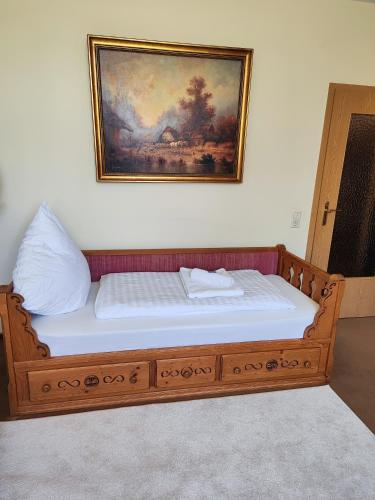 a bed in a room with a painting on the wall at Kurpark Suite in Bad Rodach
