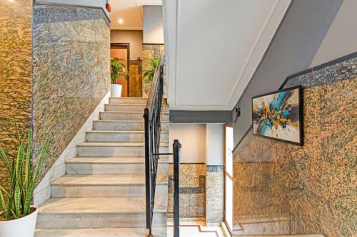 a staircase in a house with a painting on the wall at FabHotel Gulshan International - Nr Peter Cat Park Street in Kolkata