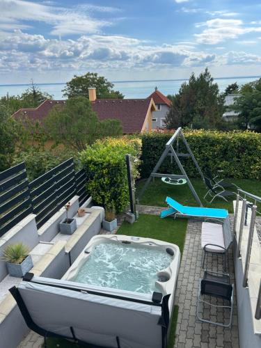 a hot tub sitting on top of a patio at Fügefa Apartman in Balatonalmádi