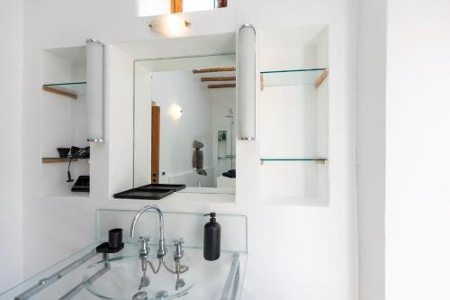 a bathroom with a sink and a mirror at Il Frantoio in Panarea