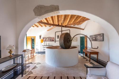 an archway in a living room with a table and chairs at Il Frantoio in Panarea