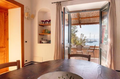 a dining room with a table and a view of the water at Il Frantoio in Panarea