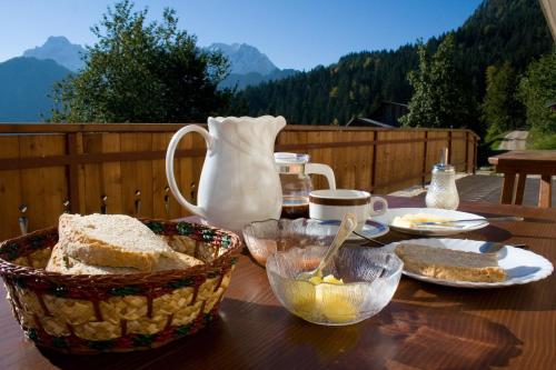 a table with bread and a vase on a table at Turistična kmetija Perk in Solčava