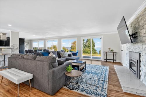 a living room with a couch and a fireplace at Oceanline 180° home in Federal Way